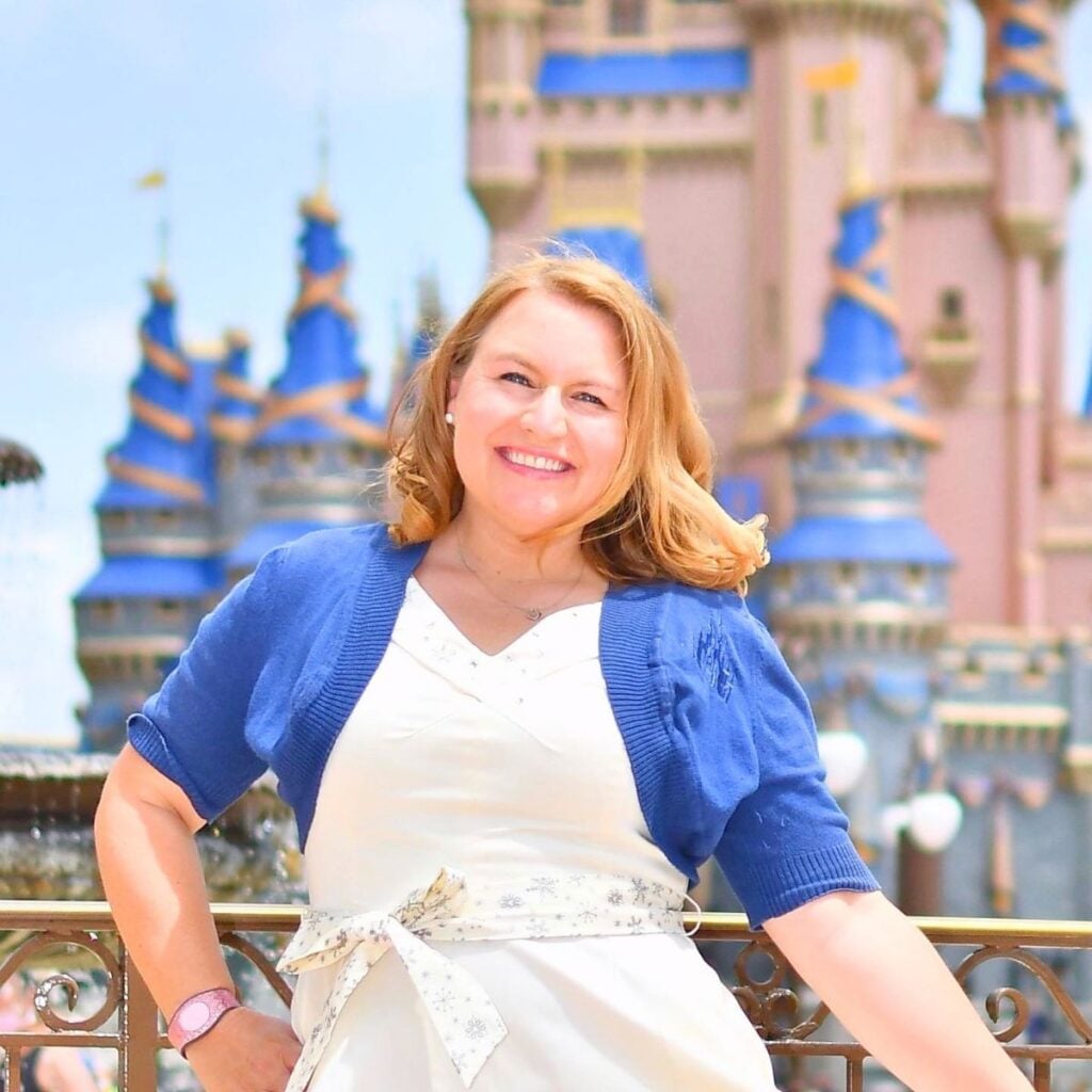 Jennifer Davis, your Lowcountry travel agent, in front of Cinderella Castle at Disney's Magic Kingdom