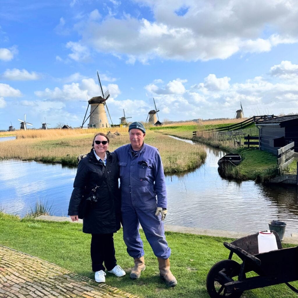 Jennifer Davis, your Lowcountry travel agent, pictured with a Miller at the Kinderdijk Windmills in The Netherlands