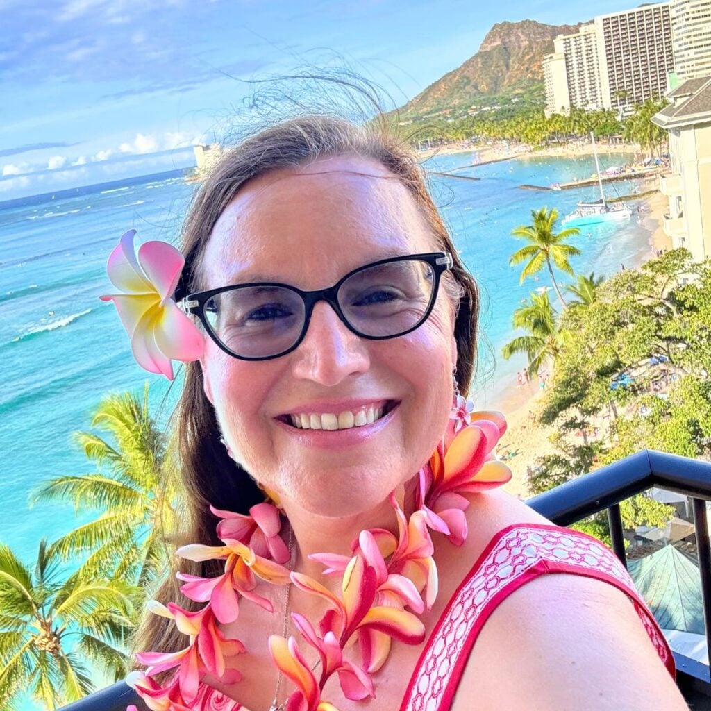 Jennifer Davis, your Lowcountry travel agent, in Honolulu, Hawaii wearing a lei