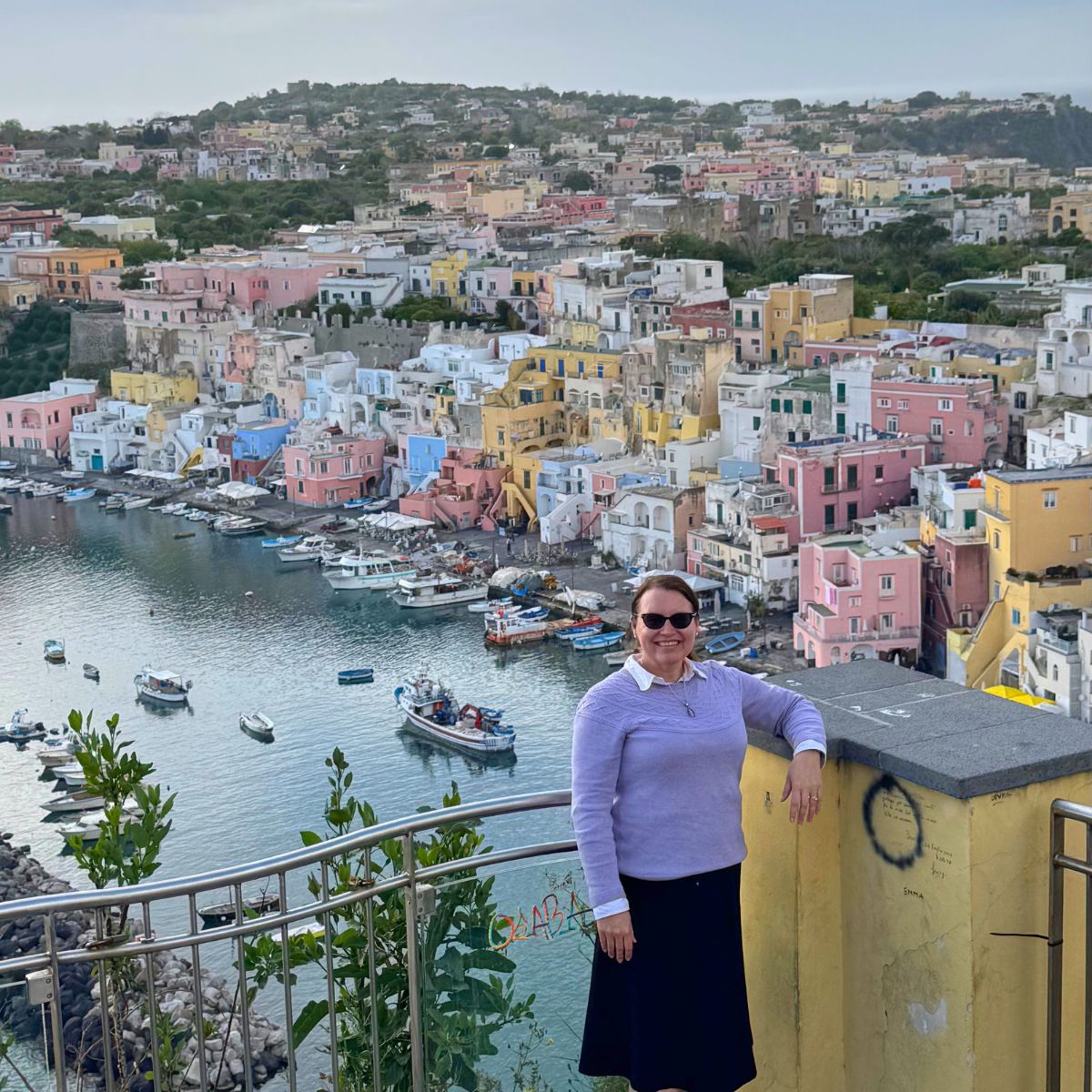 Jennifer Davis, Your Lowcountry travel agent, overlooking Procida island, Italy