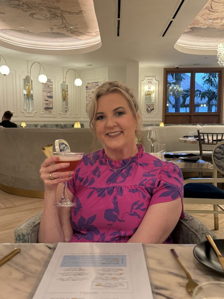 Rachel Palmer toasting a drink at Sandals Dunns River