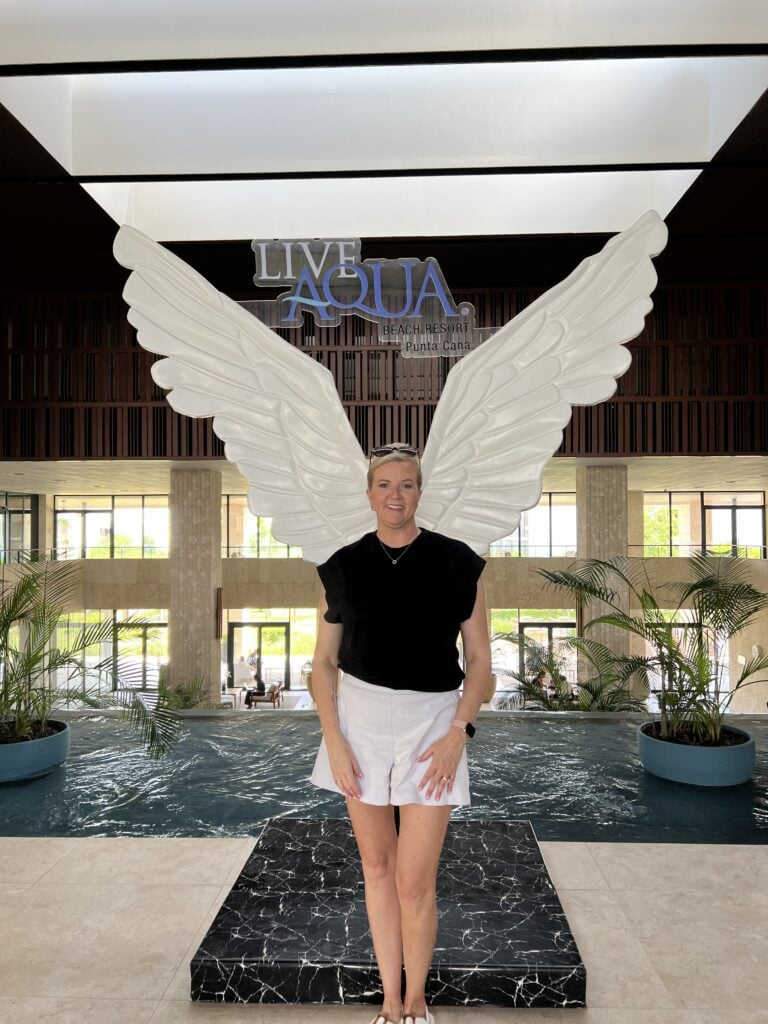 Rachel Palmer in front of the Wings statue at Live Aqua